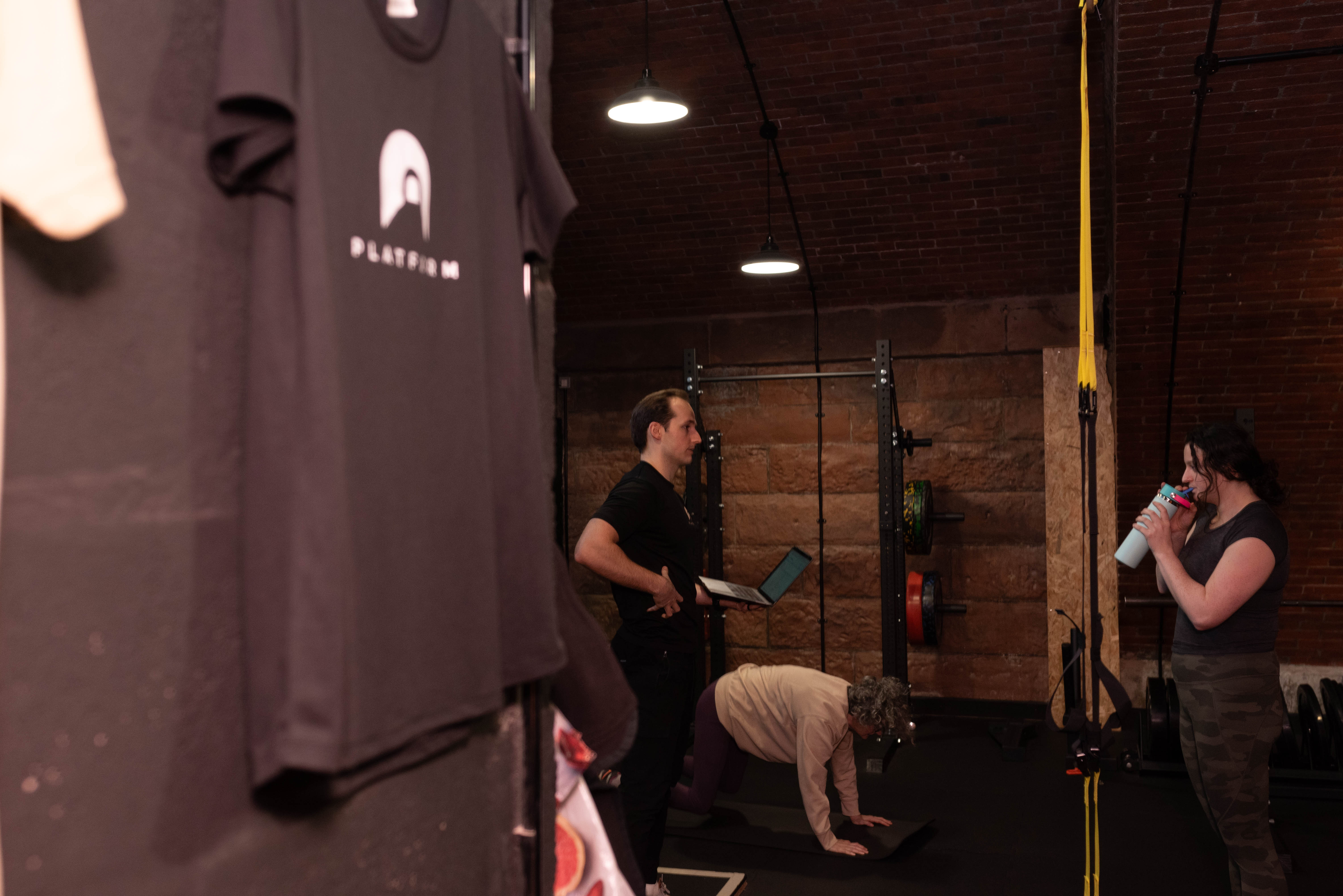 Jamie Henderson reviewing a client programme on a laptop at Platform Health and Fitness