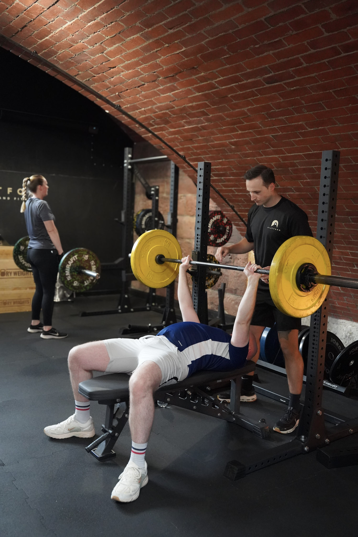 Personal trainer coaching a client through a barbell bench press at Platform Health and Fitness, Edinburgh